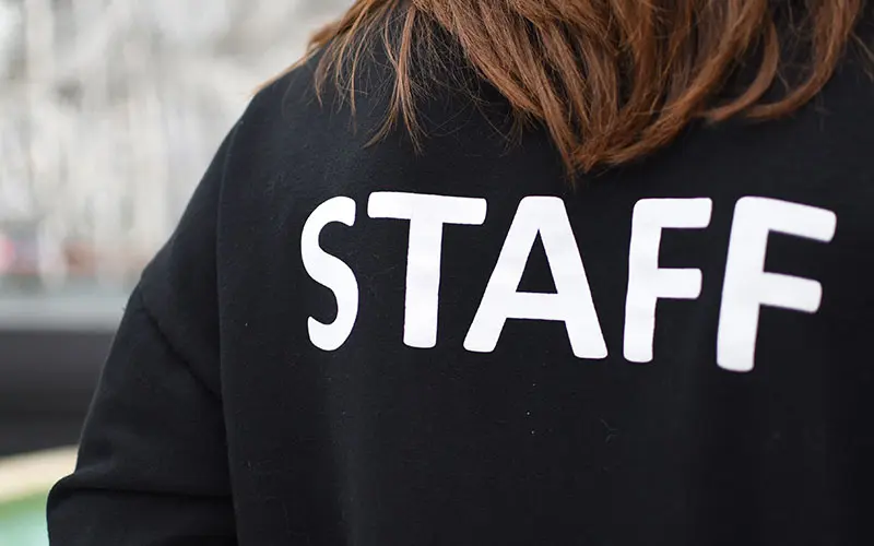 Person wearing a top with STAFF printed across the back
