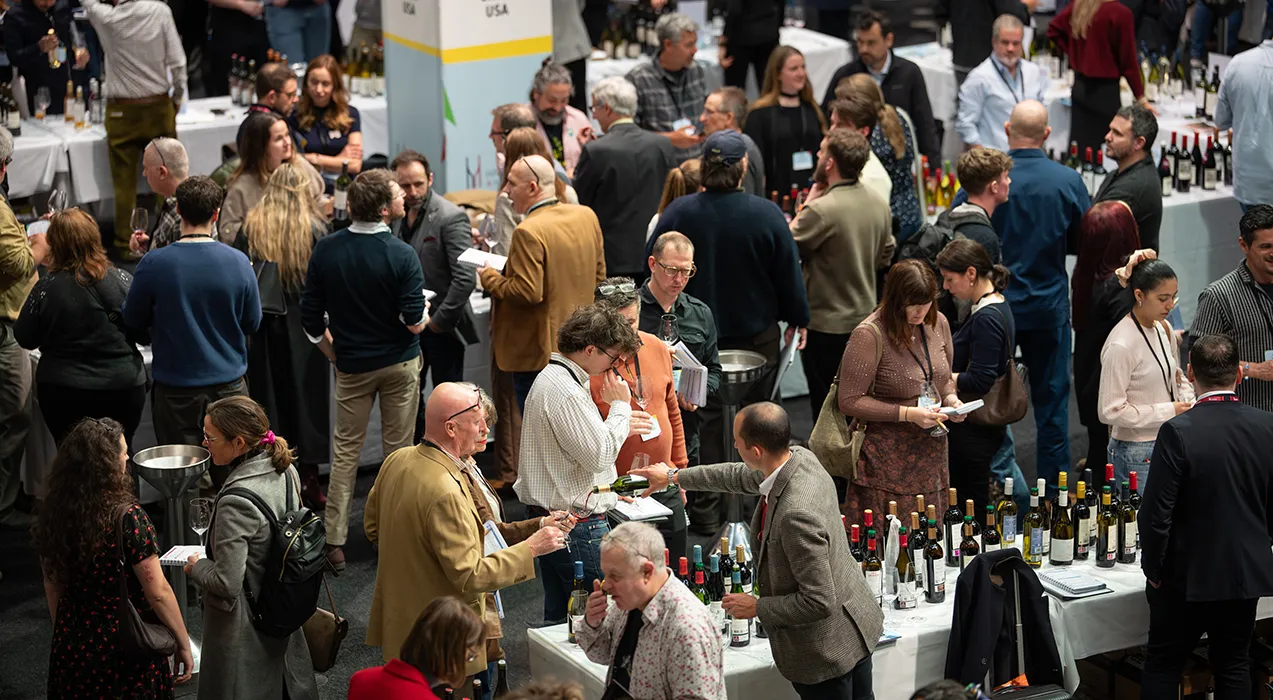 View from high up showing many people tasting wines at Old Billingsgate, London