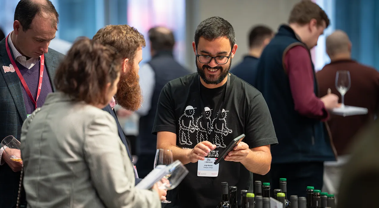People tasting wines and notes being taken on a smartphone