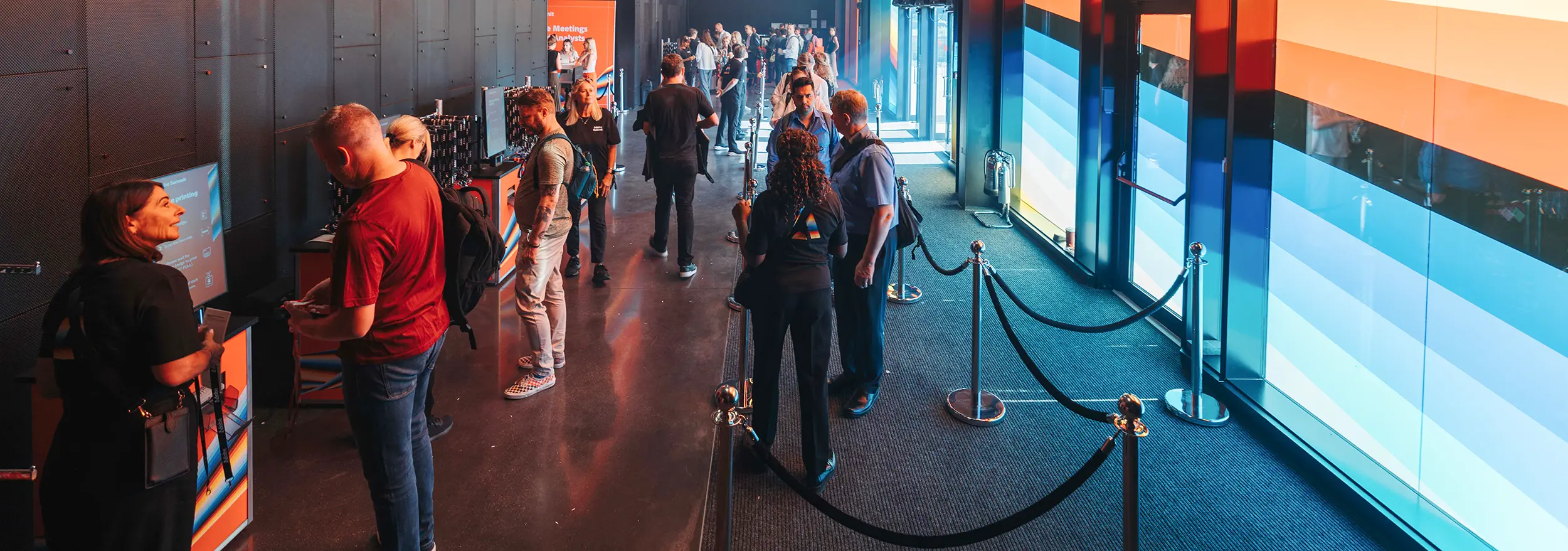 People using PrintPods in a colourful entrance foyer